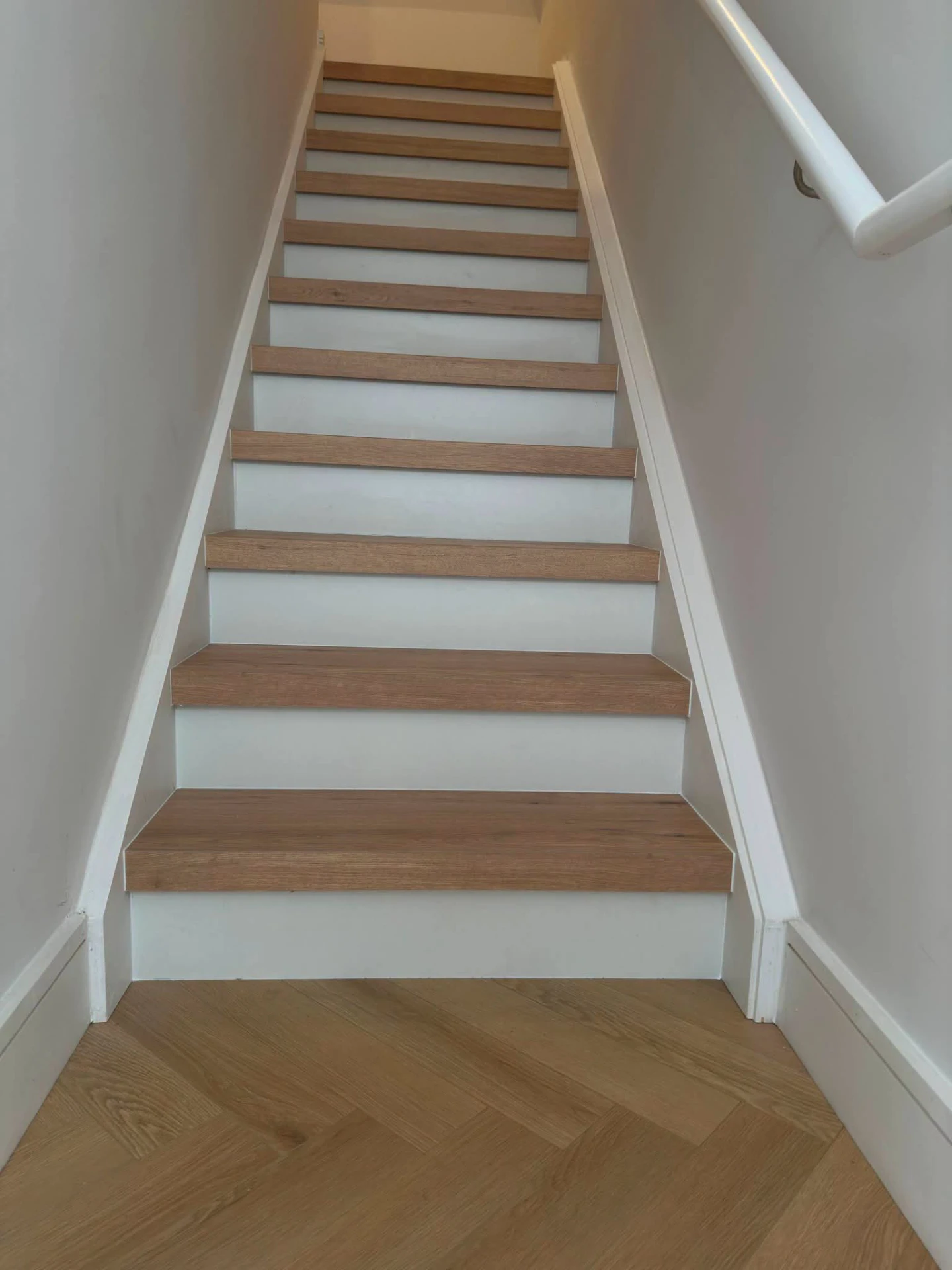 Full flight of oak-clad stairs with white painted risers